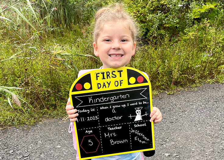 Student holding chalkboard