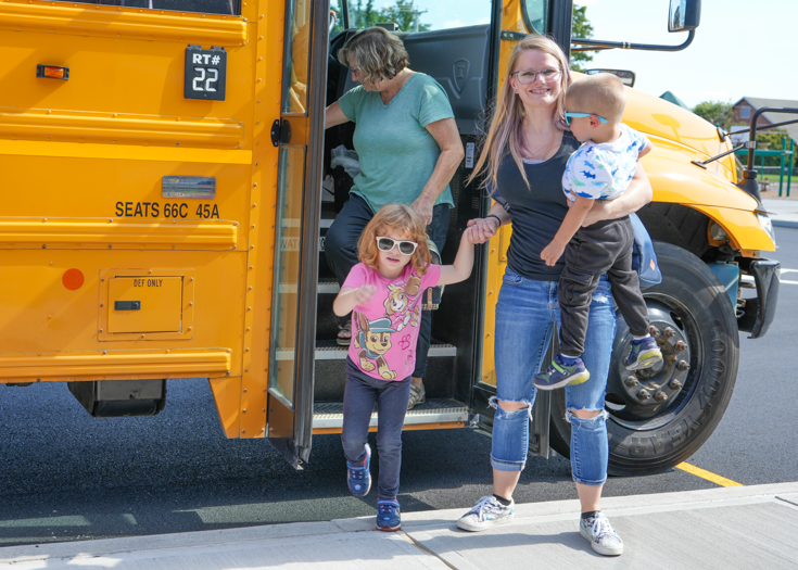 Student gets off school bus