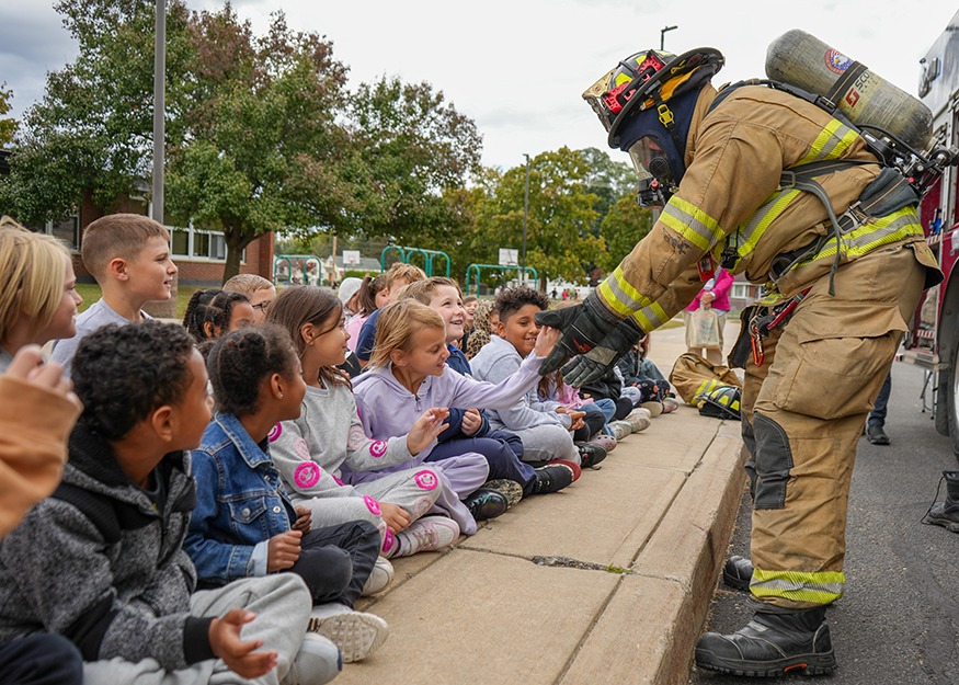 Firefighter with students