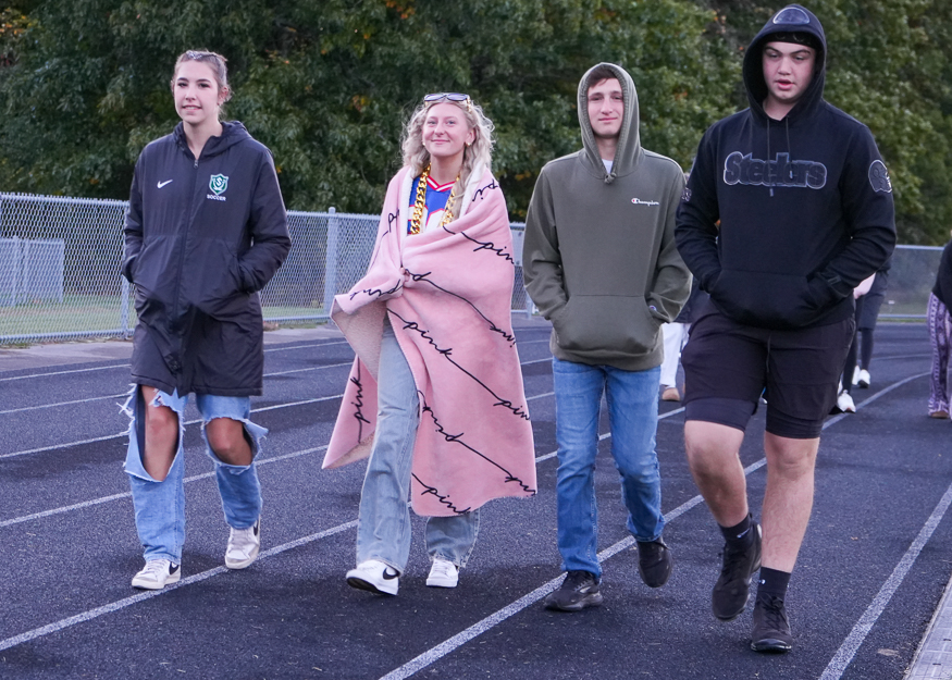 Group of students walk on track