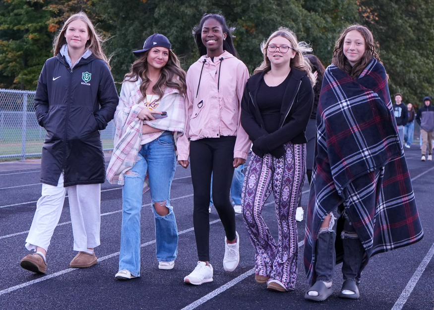 Group of students walk on track