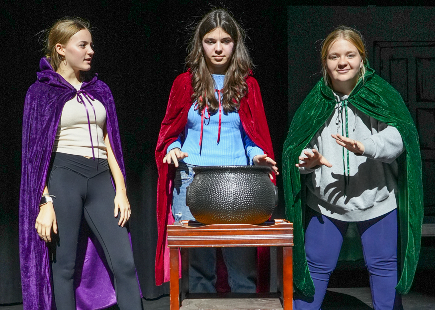 Students perform a play on stage