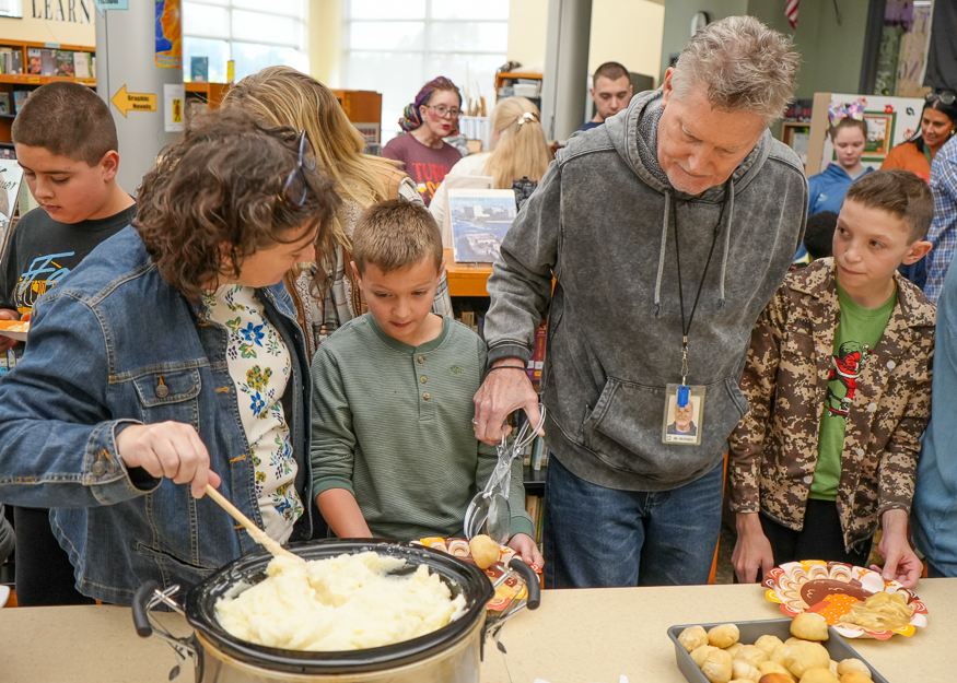 Staff serves food to students