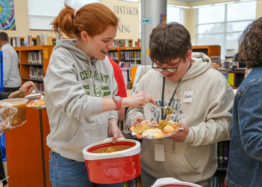 Staff serves food to student