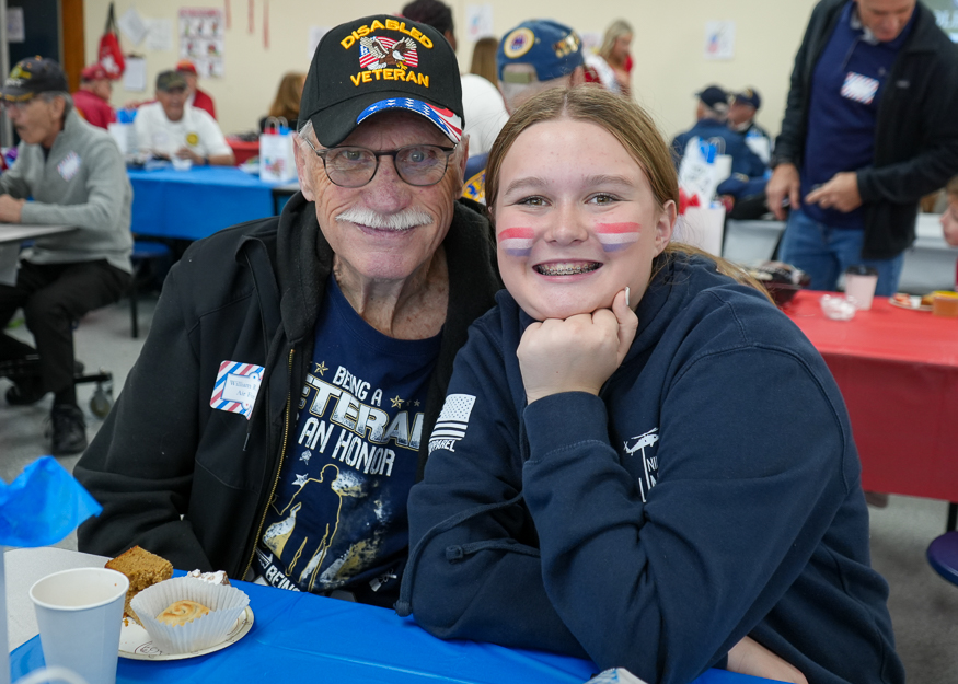 Student and veteran pose for photo