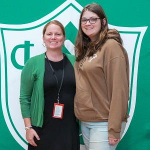 Athletic Director poses for photo with student