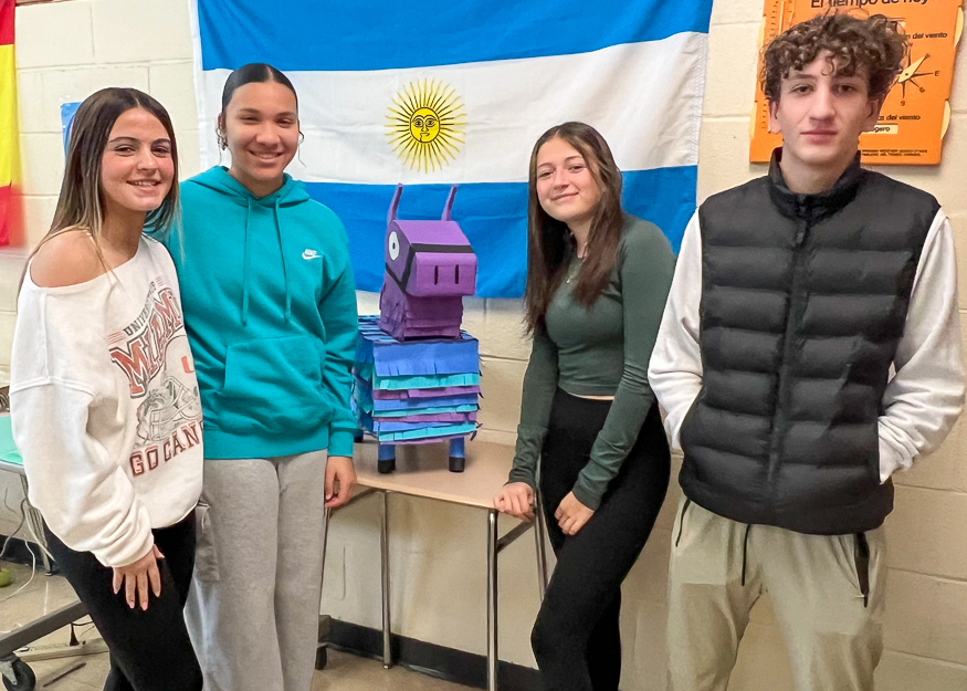 Group photo of students and pinata