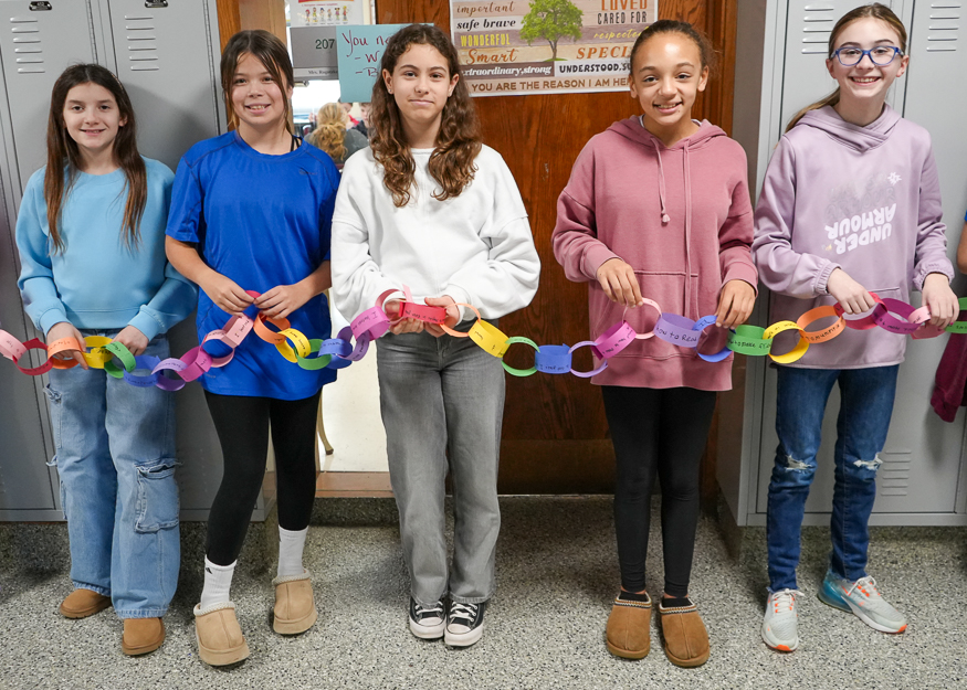 Students hold paper chain