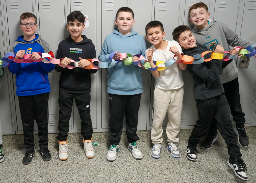 Students hold paper chain