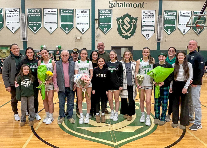 Group photo of girls basketball players and families