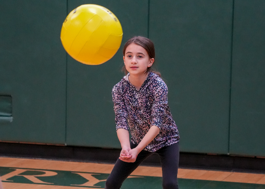 Girl hits volleyball